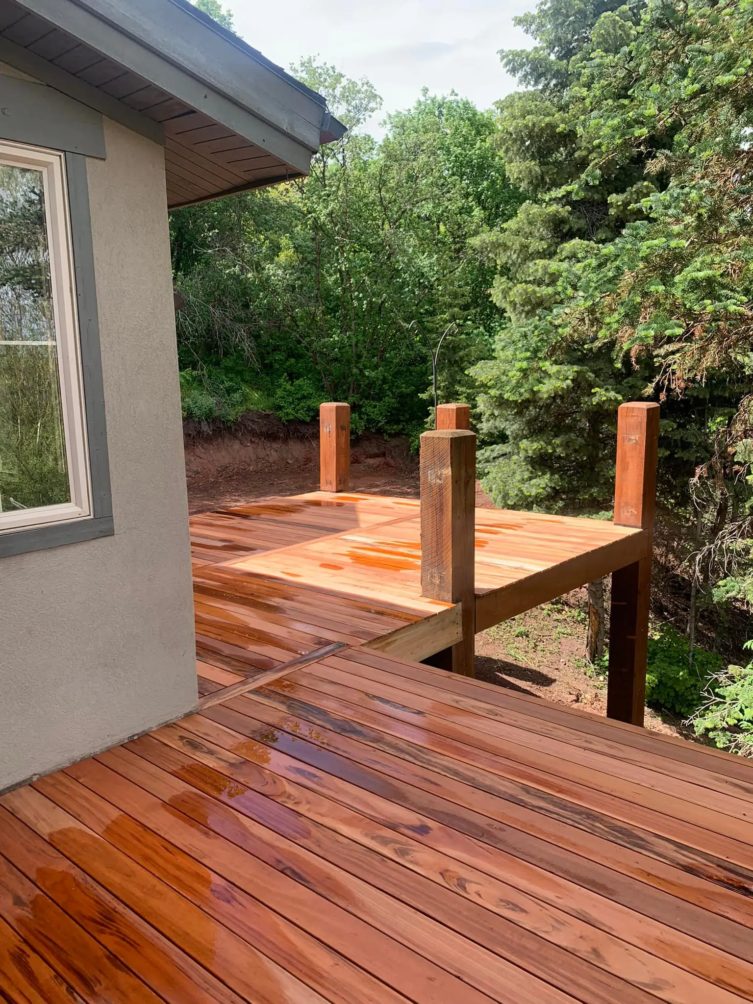 A wooden deck with trees in the background