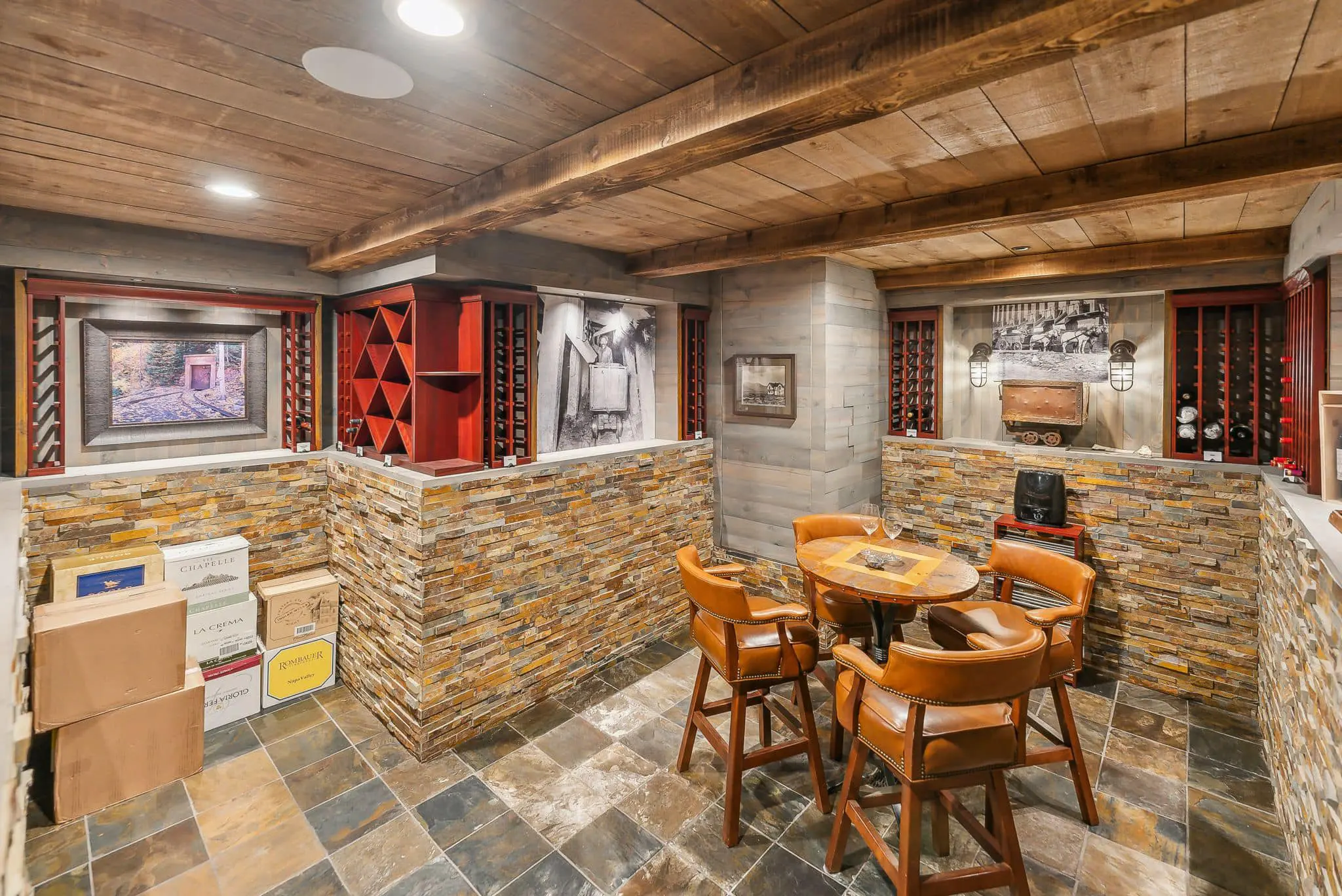 Rustic wine cellar with seating area.