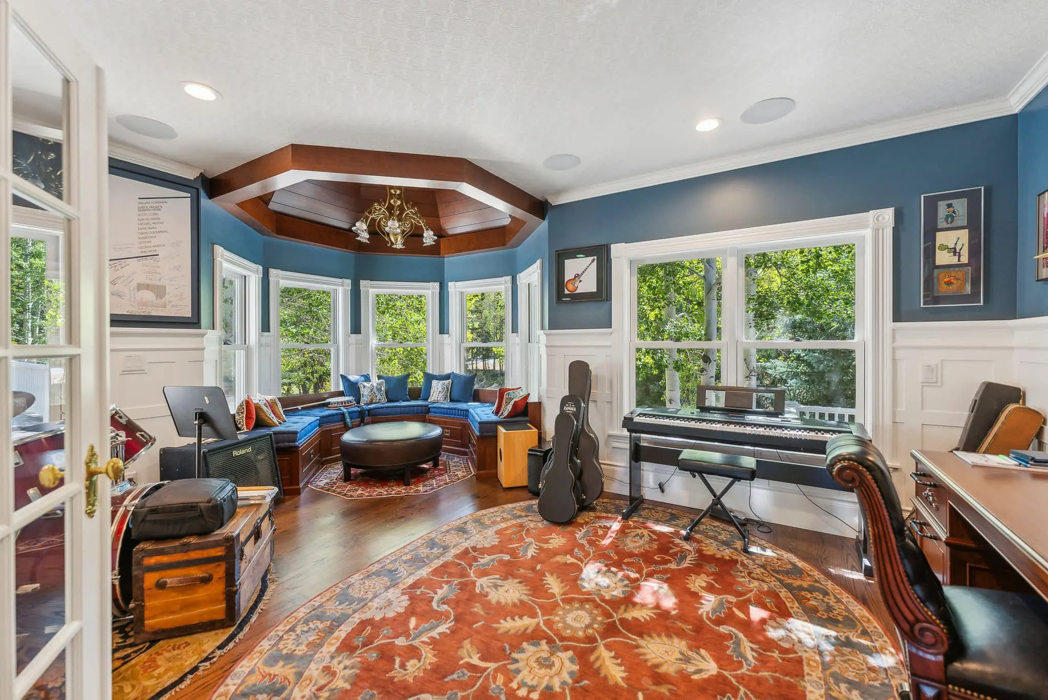 A living room with a piano and guitar in it