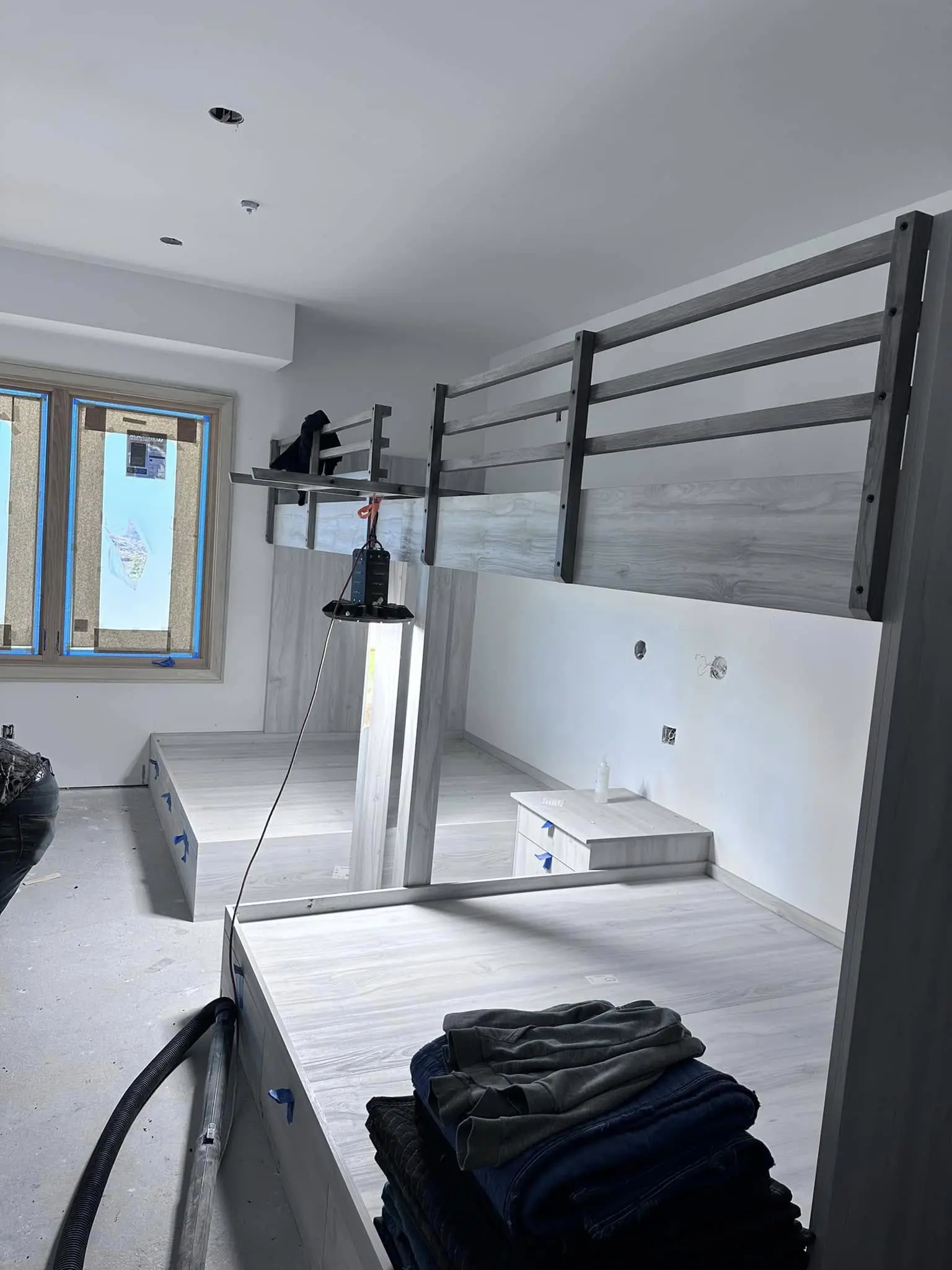 A room with two beds and a window.