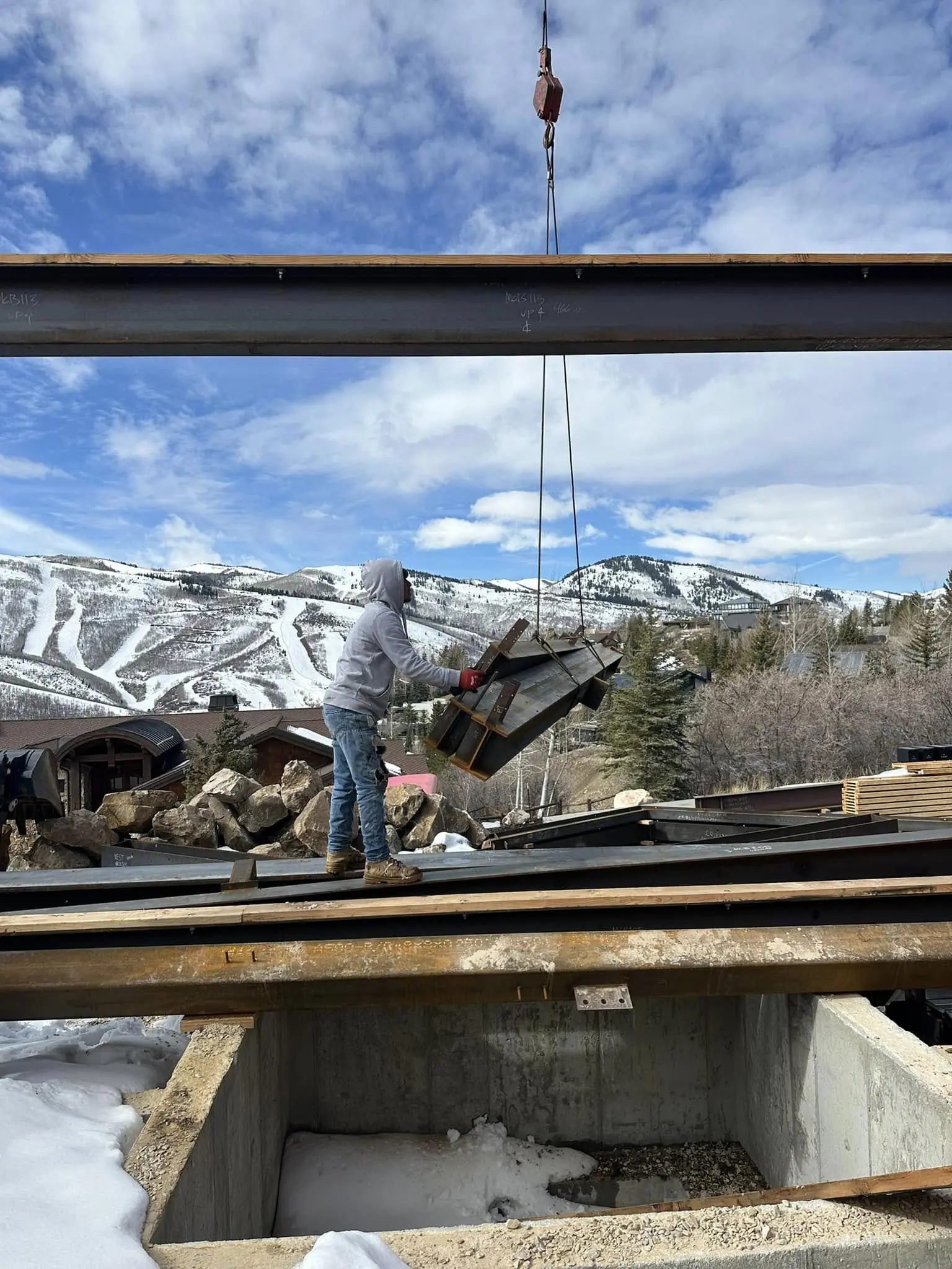 Construction worker at snowy mountain site.