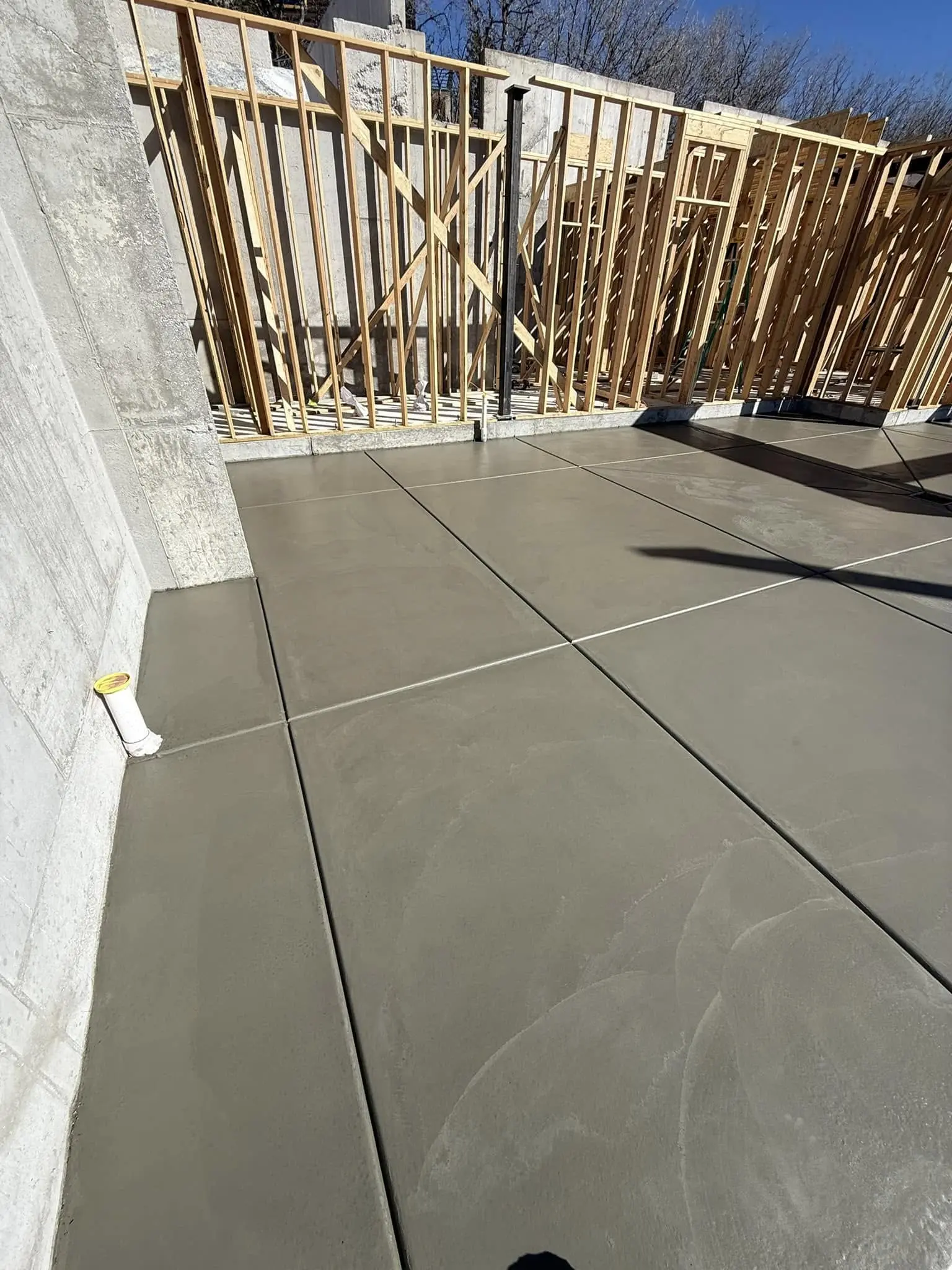 Concrete floor with wooden frame construction.