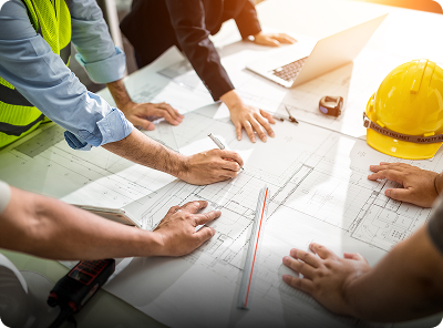 Architects reviewing blueprints on a table.