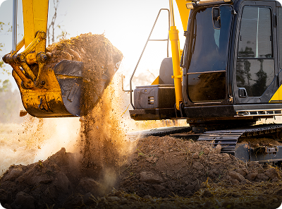 Excavator moving earth at construction site.