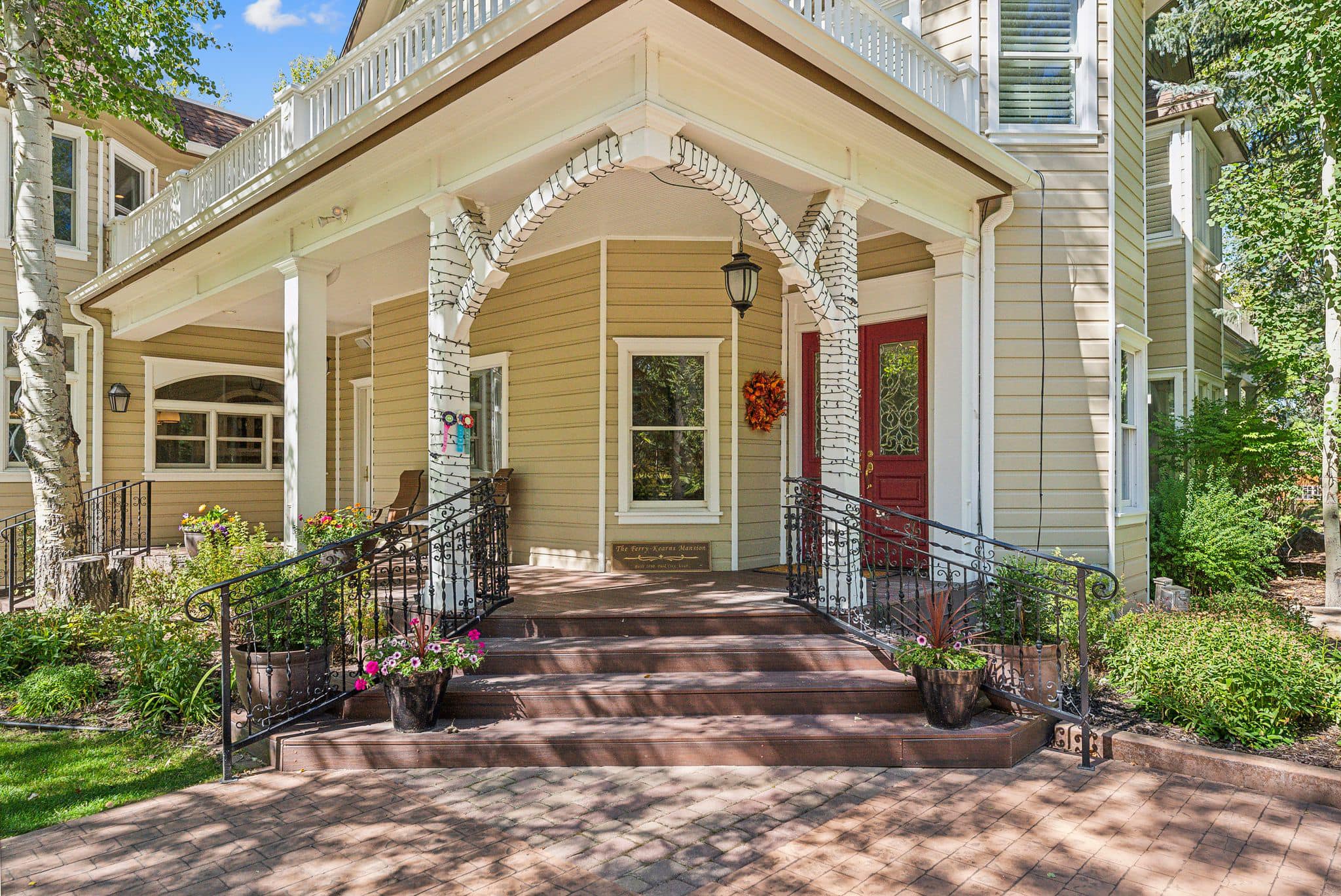 A porch with steps leading to the front door.